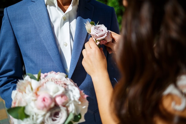 Beautiful wedding bouquet of flowers in the hands of the newlyweds