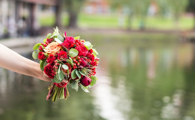 Beautiful wedding bouquet in hands of the bride close-up