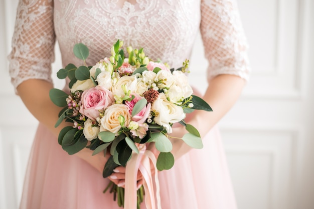 Beautiful wedding bouquet in hands of the bride. Rose, pink and Peach. 