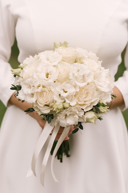 Beautiful wedding bouquet in the hands of the bride