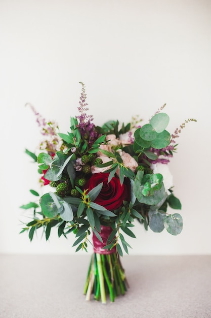 Beautiful wedding bouquet in the hands of the bride.