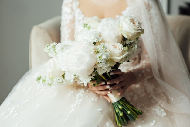 Beautiful wedding bouquet in hands of the bride