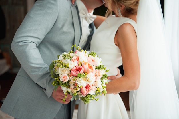 Beautiful wedding bouquet in hands of the bride