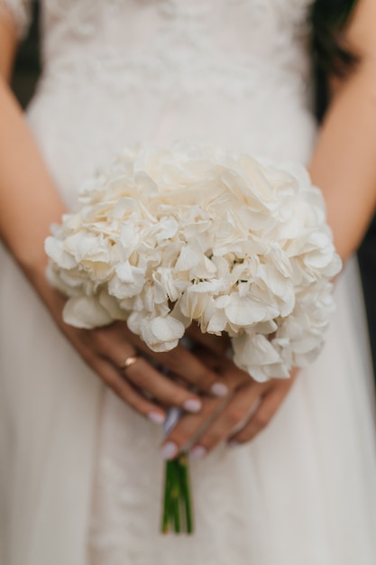 Beautiful wedding bouquet in hands of the bride