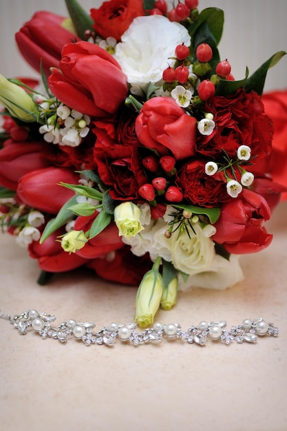 Beautiful wedding bouquet and necklace on the table