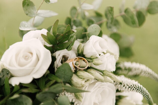 Beautiful wedding bouquet with protea and roses wedding rings