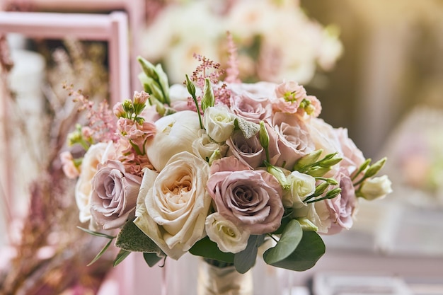 Beautiful wedding bouquet with roses standing on the table