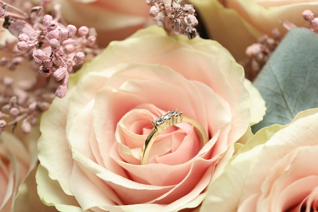 Beautiful wedding bouquet with wedding ring, close up