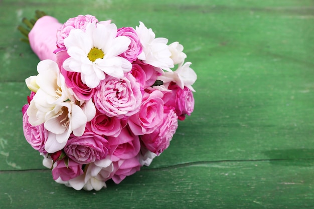 Beautiful wedding bouquet on wooden background