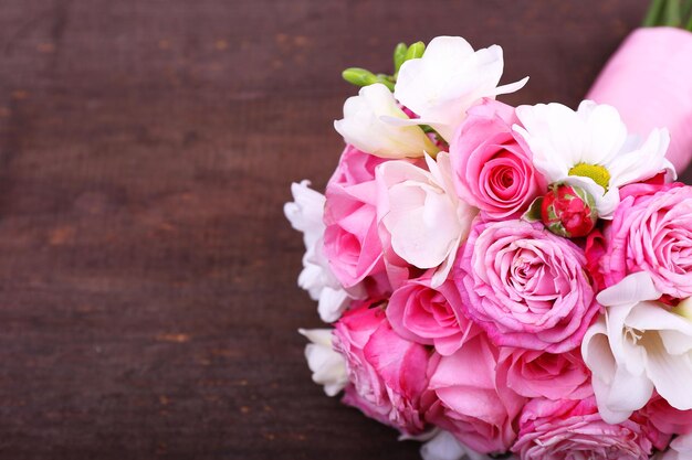 Beautiful wedding bouquet on wooden background