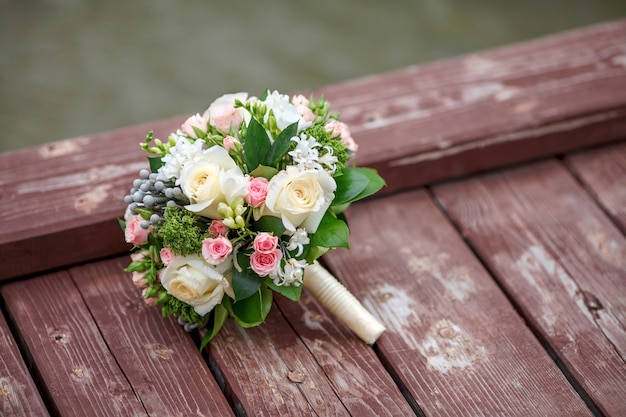 Beautiful wedding bouquet on wooden surface