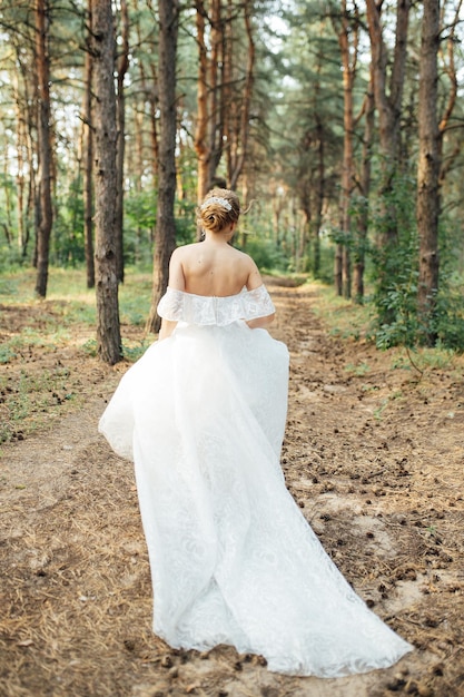 Beautiful wedding bride running in the garden