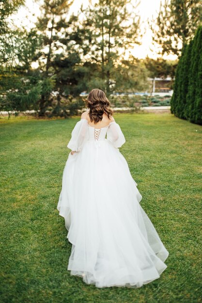 Beautiful wedding bride running in the garden