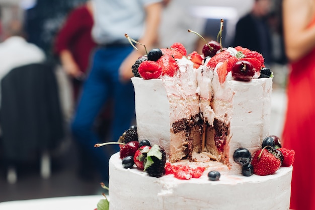 Beautiful wedding cake with berries.sliced wedding cake in close-up.