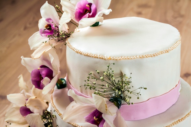 Beautiful wedding cake with flowers, close up of cake with blurr