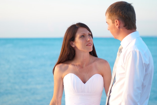 Beautiful wedding couple bride and groom at the beach