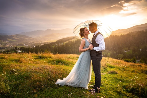 Beautiful wedding couple bride and groom in love on the background of mountains