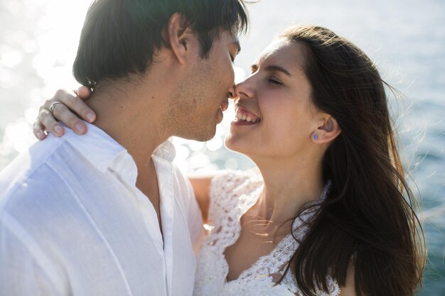 Beautiful wedding couple bride and groom on yacht at wedding day outdoors in the sea