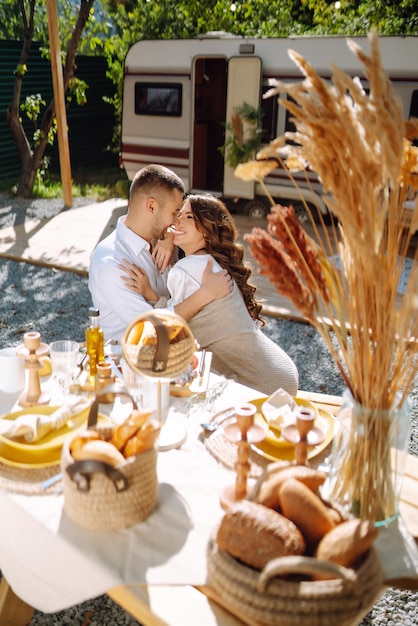 Beautiful wedding couple laugh and kiss relaxing in rv camping in a trailer Romantic moment