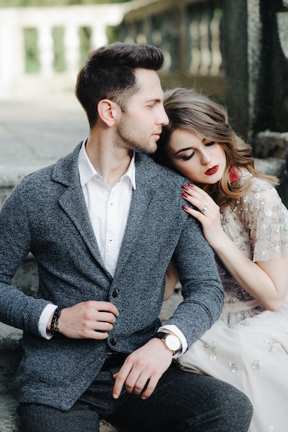 Beautiful wedding couple outside the castle on the stairs