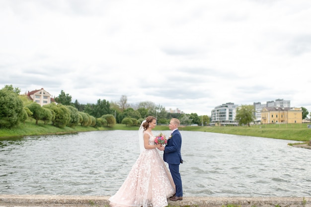 Beautiful wedding couple posing for photographer at nature