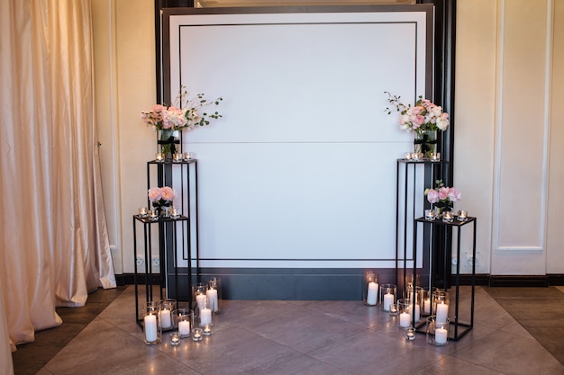 Beautiful wedding decor arch for the ceremony. Wedding photo zone at the festival with fresh flowers.