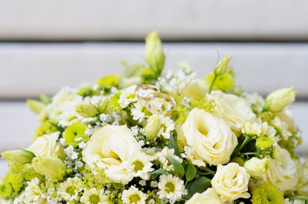 Beautiful wedding flowers bouquet with two wedding rings