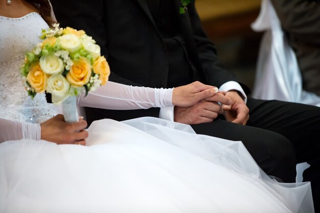 Beautiful wedding roses bouquet in hands of the bride