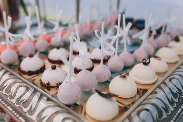 Beautiful wedding sweet buffet with decor and green.