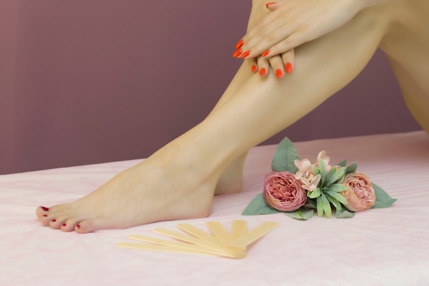 Beautiful well-groomed female legs. Foot care. Depilation of hair on the legs.