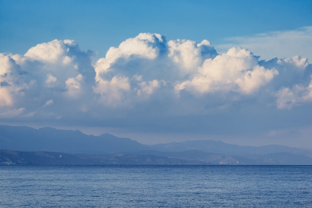 Beautiful white clouds on blue sky, and mountains.