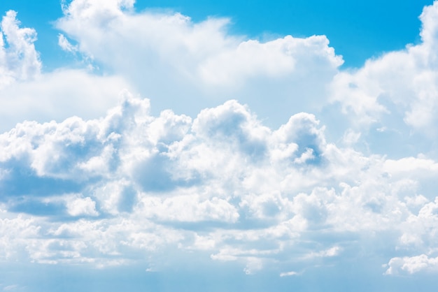 Beautiful white cumulonimbus clouds against the background of the bright blue sky