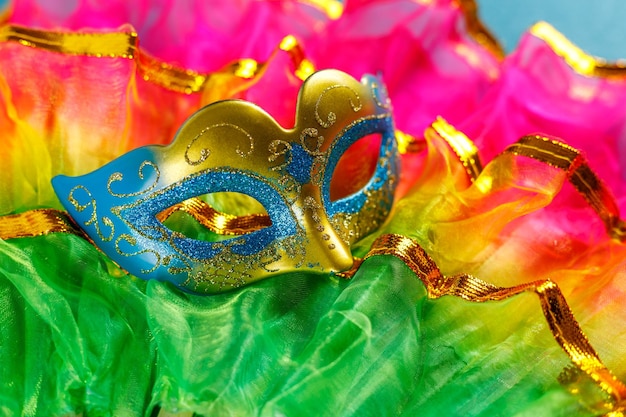 beautiful white and multicolor carnival masks on a blue background purim mardi gras top view