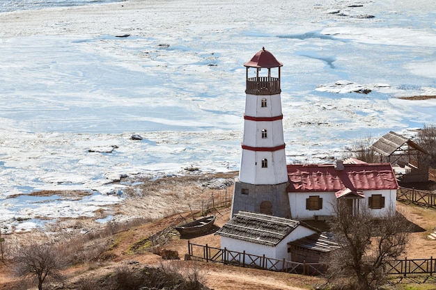 Beautiful white red lighthouse with farm utility houses in Merzhanovo Rostov on Don Russian region