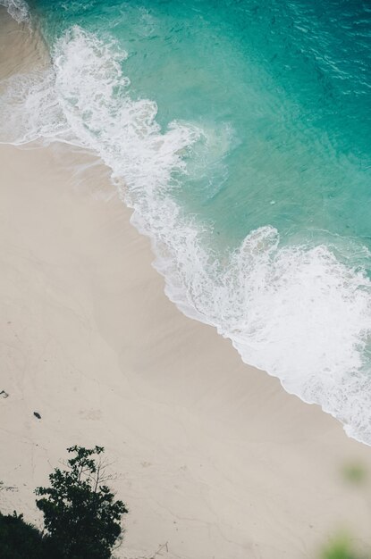 Beautiful white sand coastline view with blue sea water