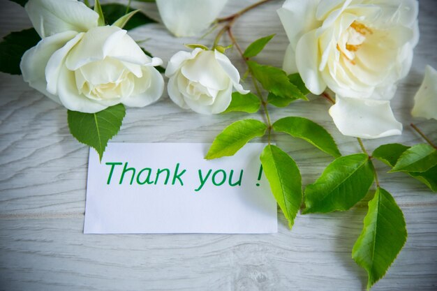 Beautiful white summer roses on a wooden table