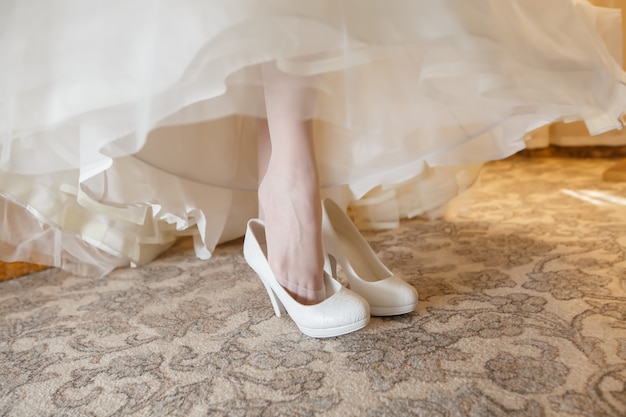 The beautiful white wedding Shoes on bride