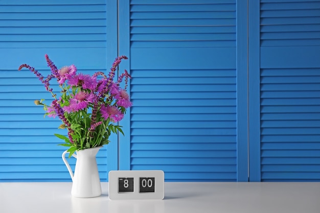 Beautiful wildflowers bouquet on blue folding screen