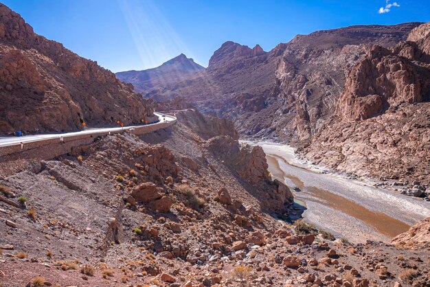 Beautiful winding road through mountains with river in summer