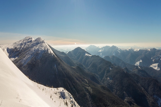 Beautiful winter landscape. Steep mountain hill slope with white deep snow,