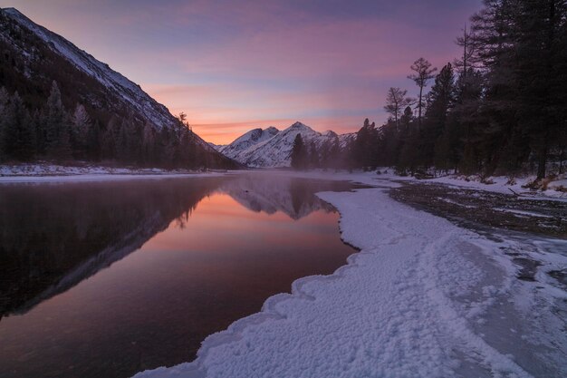 Beautiful winter landscape with mountains and a sunset sky