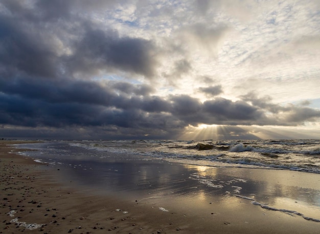 Beautiful winter sunset on the sandy beach of the Baltic Sea in Lithuania Klaipeda