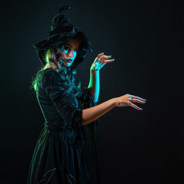 Beautiful witch with a hat make spell halloween party witches  sabbath