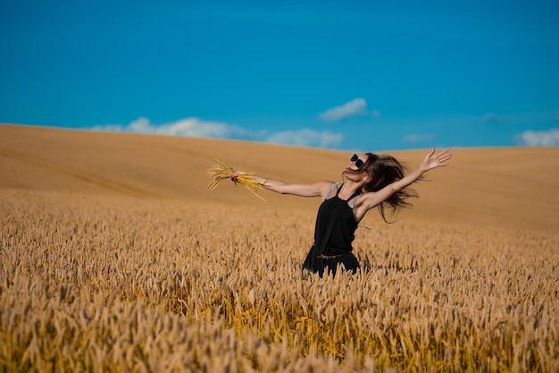 Beautiful woman on agriculture field in summer