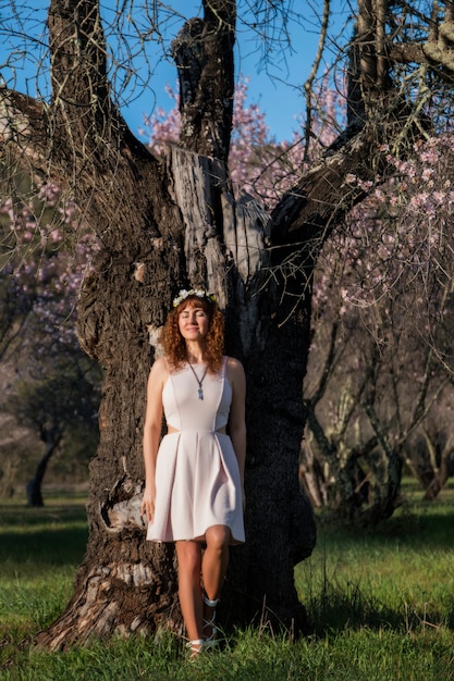 Beautiful woman next to a almond tree