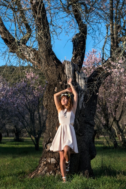 Beautiful woman next to a almond tree