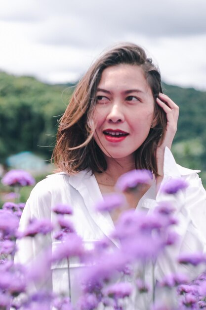 Beautiful woman amidst flowering plants