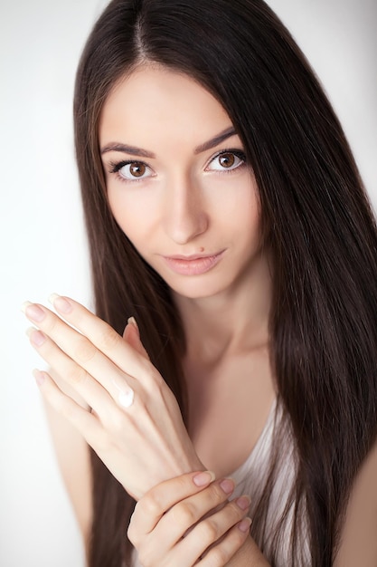 Beautiful Woman Applying Cosmetic Face Cream