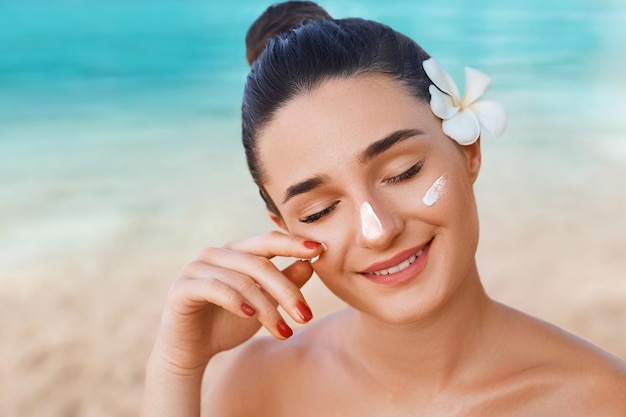 Beautiful Woman Applying on Face Sunscreen Solar Cream Skin care Sun protectionSuncream