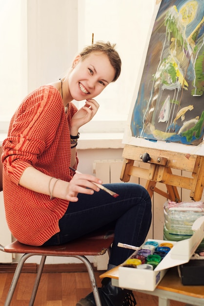 Beautiful woman artist drawing her picture